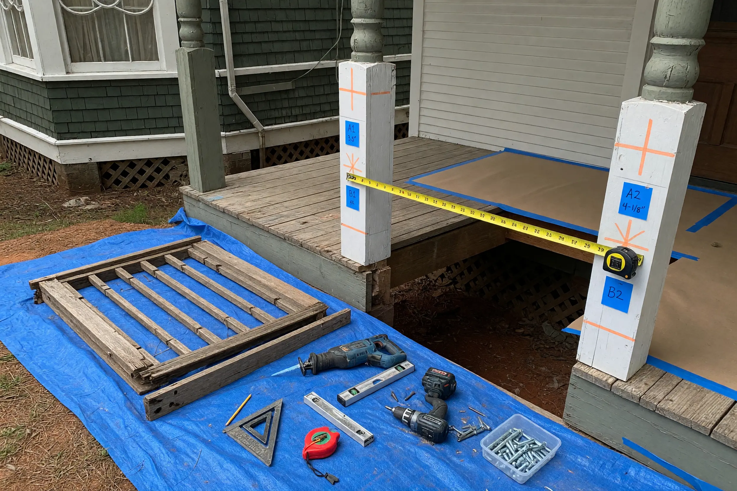 A weathered porch rail beside the prepared opening for a new metal guard