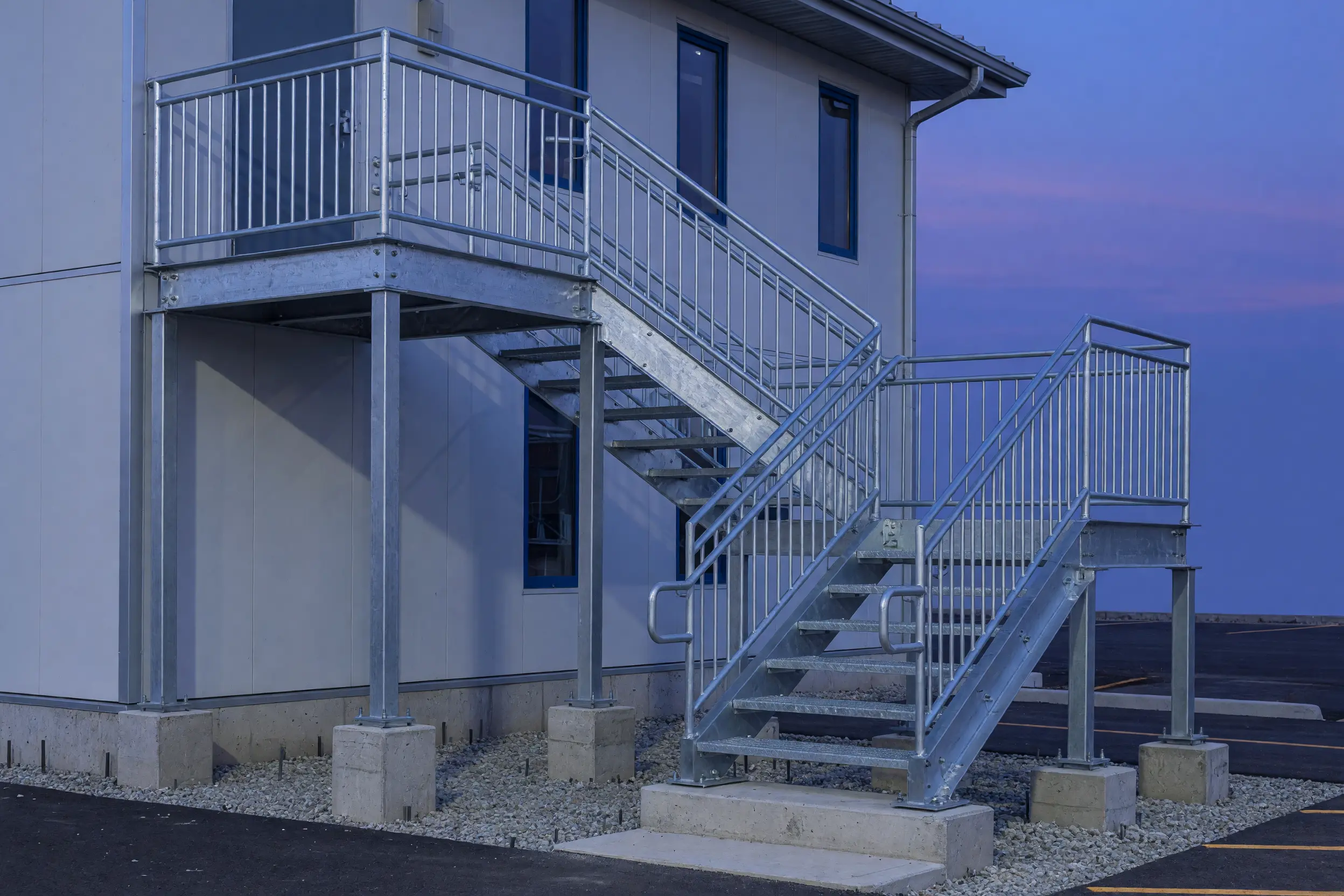 Galvanized steel switchback stair and guard at a small commercial building